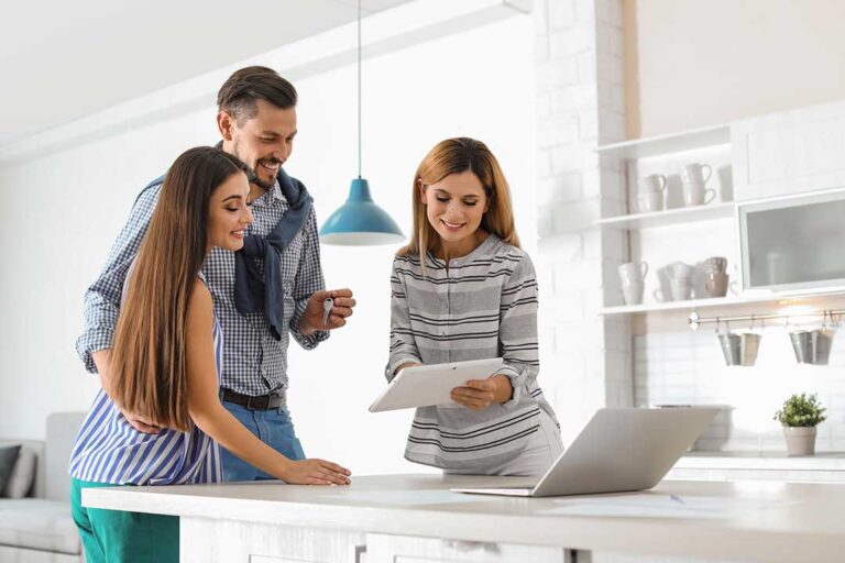 Home sellers review a purchase offer and inspection report at a kitchen table.